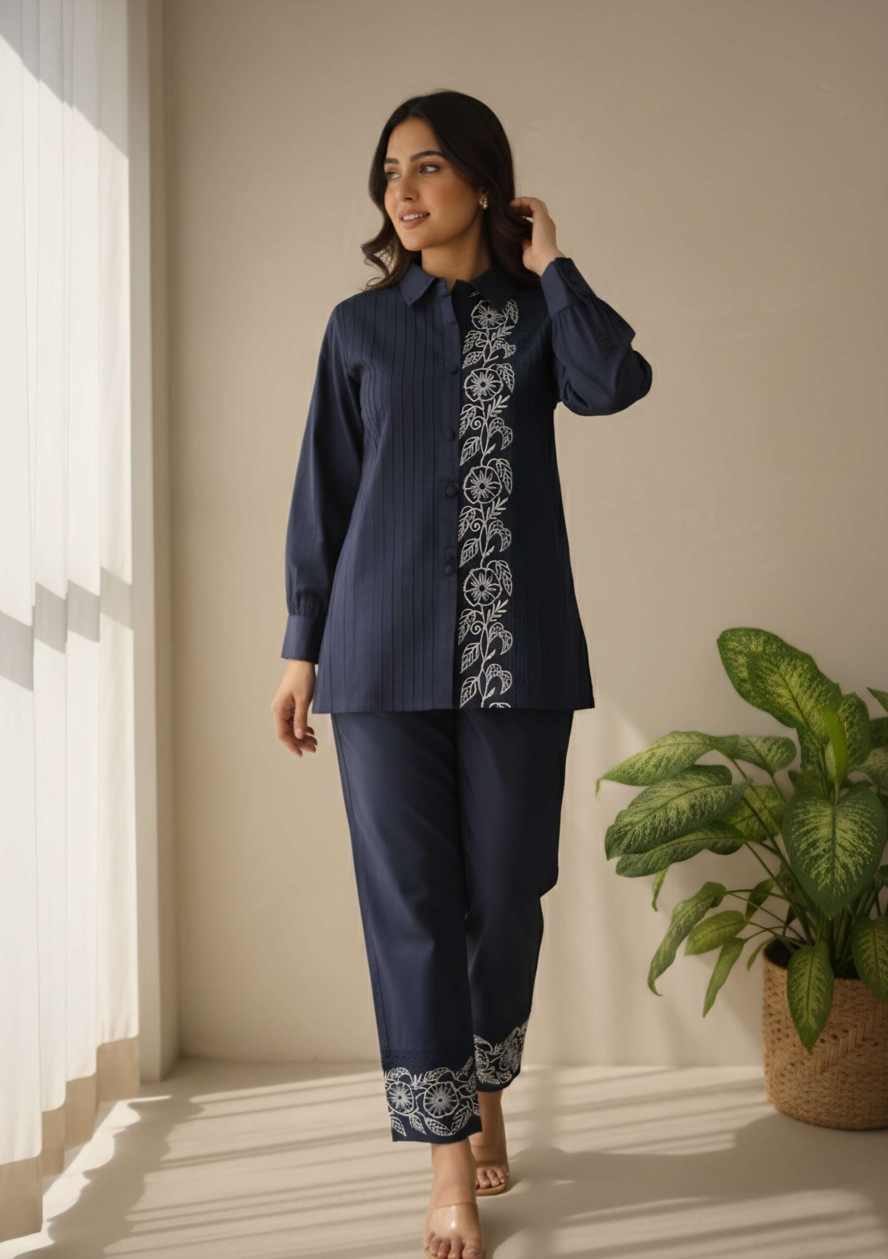 Model wearing ilaaha's navy blue collared embroidered co-ord set with white floral embroidery.